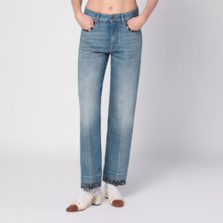 Washed blue jeans with floral fabric trims
